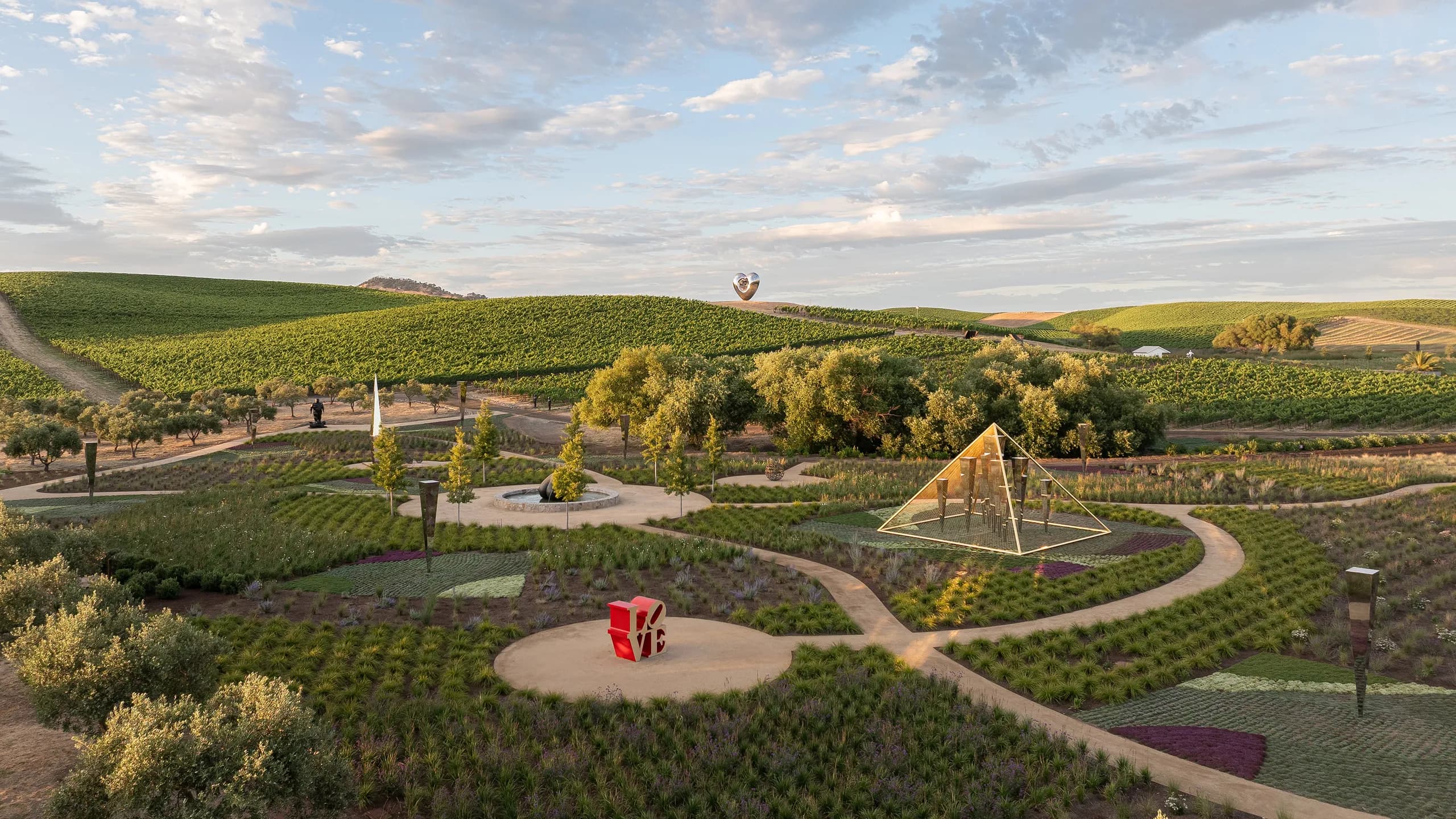 Rows of ornamental plants and trees arranged along a garden path